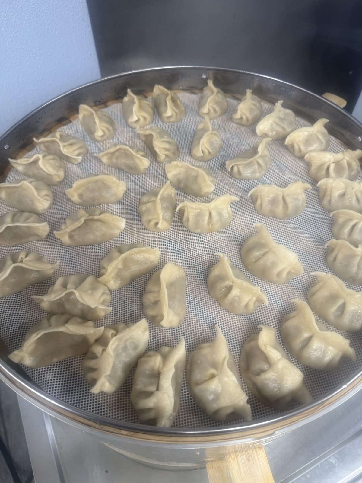 Dumplings on a tray ready to be served with sauce